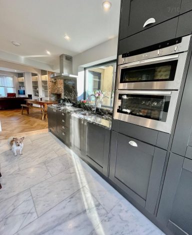 Install grey fronted kitchen with black & white marble worktop, light Marble floor