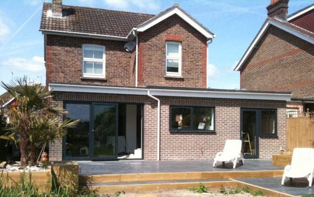 Single story extension, with brickwork, sliding doors, patio area & timber planters