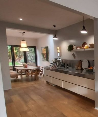 Kitchen, diner with wood flooring, hanging lights, white kitchen units