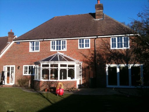 Two story side extension, brick faced, with bi-fold doors & pitched tiled roof